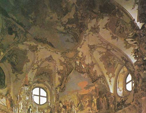 In late Baroque, the time-honored Italian ambition to paint a many-figured fresco ceiling decoration was carried out with greatest virtuosity. In the dining-room of the Wurzburg Residenz, Germany, the 18th century Venetian painter, Giovanni Battista Tiepolo not only worked on an oval field but dispensed with an internal painted architectural framework, so that the whole vast design occupies a single unit of space and spills out on to the white and gilt stucco surround.