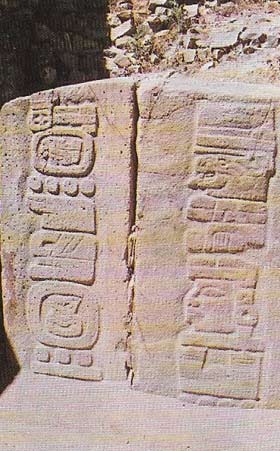 Two sculptured stone slabs or stelae at Monte Alban bear short inscriptions in a form of hieroglyphic writing, including long bars and round discs that probably denote numbers, a bar equaling 5 and a disk 1.